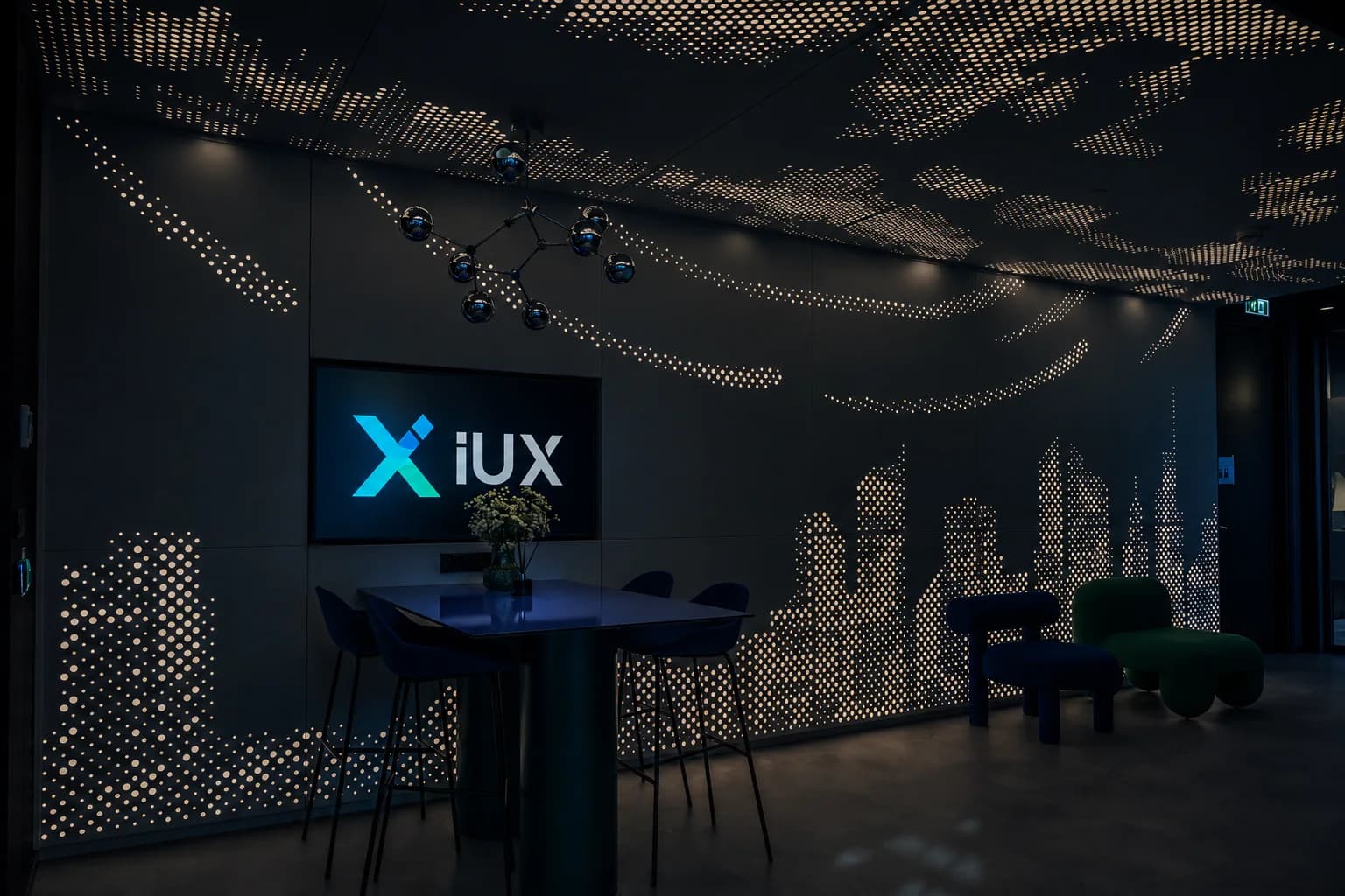 The IUX office, with a perforated wall lit as a city skyline